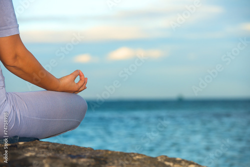 Woman sitting in yoga lotus pose