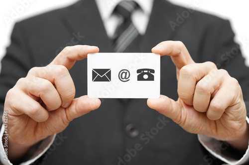 businessman hold business card with email,mail, phone icon. Cont