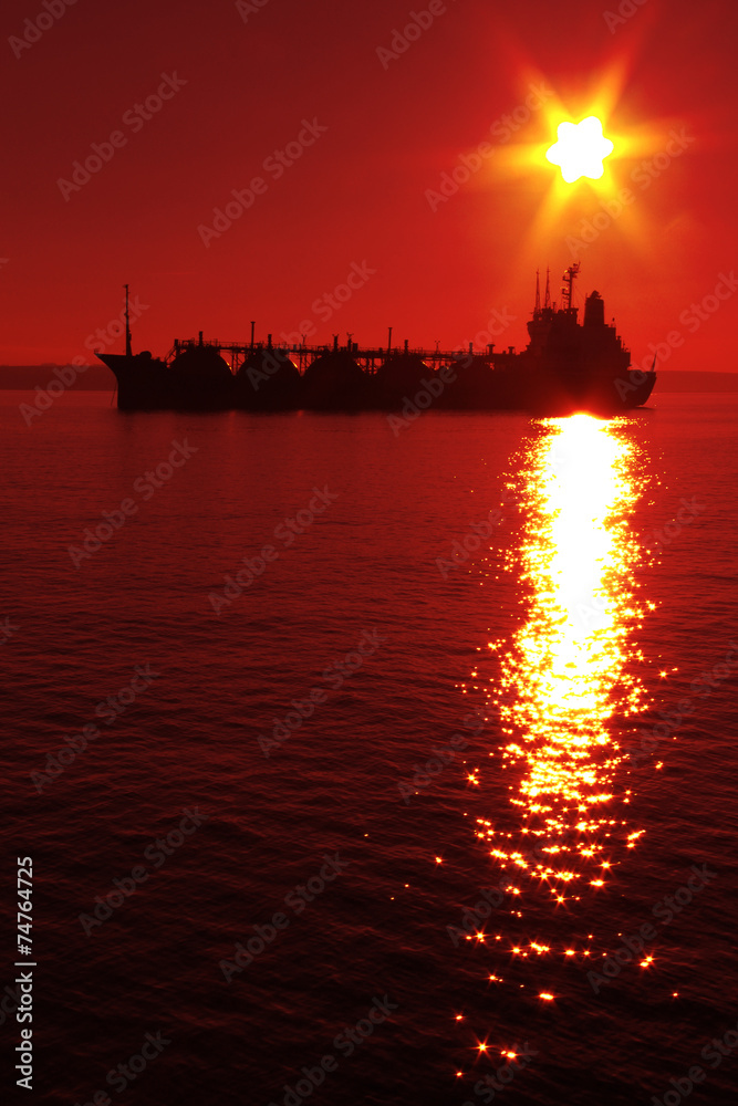 silhouette tanker on sunset background