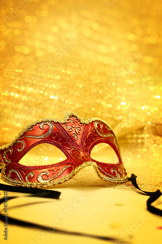 Vintage carnival mask in golden background