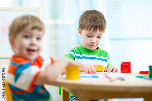 kids painting in daycare or nursery or playschool
