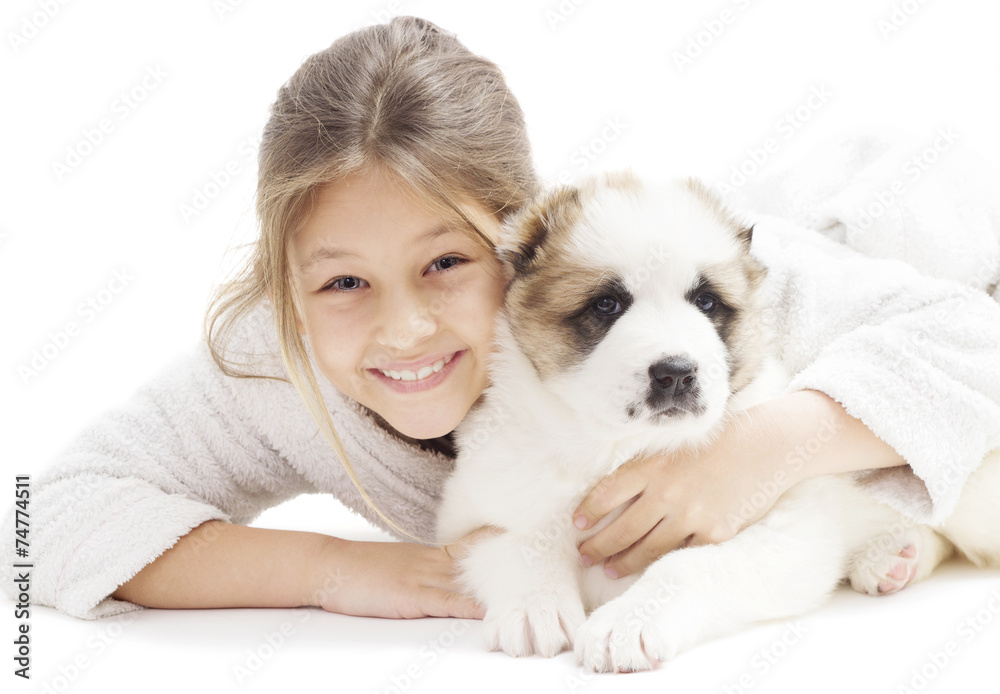 kid and Caucasian Shepherd puppy on a white background isolated kid and Caucasian Shepherd puppy on a white background isolated