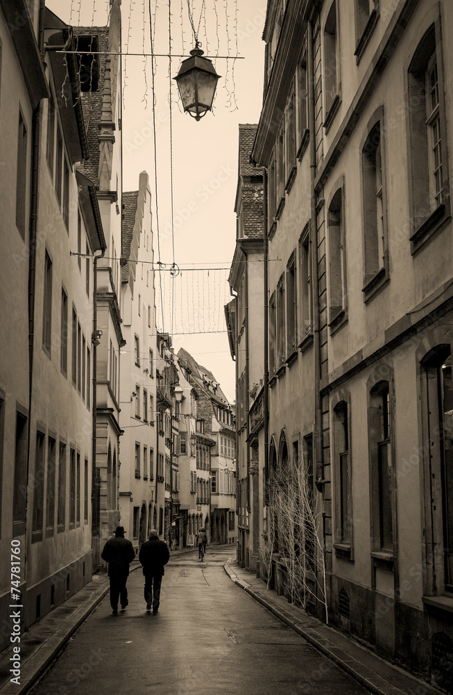Rainy street in France, vertical, in sepia