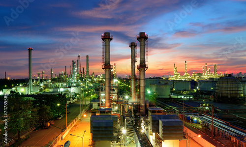 Oil refinery plant at sunset, The night view of petroleum and petrochemical factory with distillation column, drum and pipeline. Gas, diesel and chemical business industry is important for economy. photo