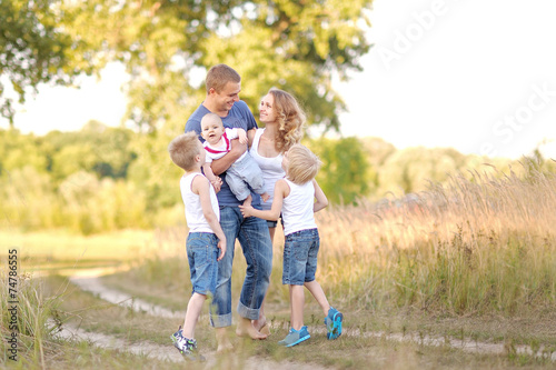 portrait of happy family relaxing in nature summer