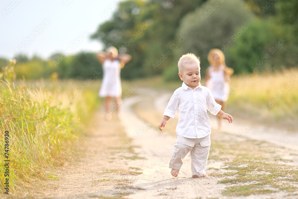 Fototapeta premium portrait of a Little boy playing in summer nature