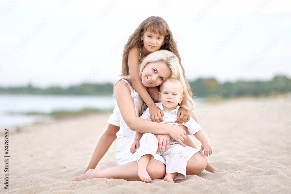 Mom with son and daughter in summer nature Mom with son and daughter in summer nature