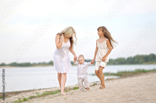 Mom with son and daughter in summer nature
