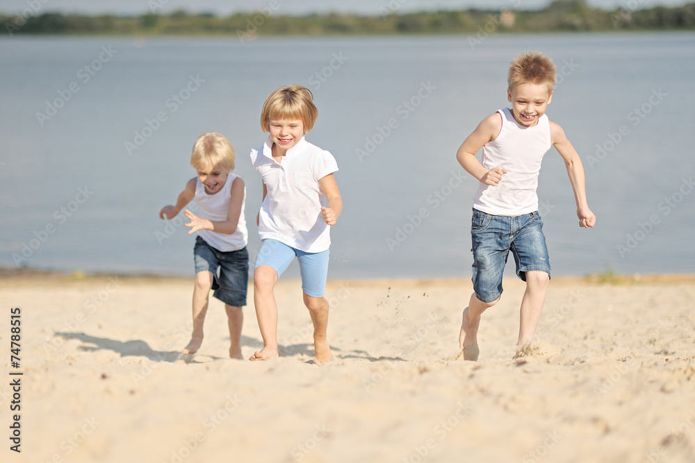 Portrait of three children playing on the beach Portrait of three children playing on the beach