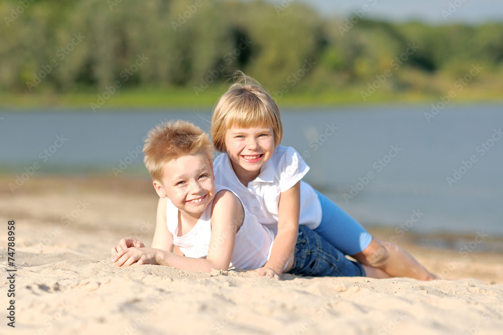 Portrait of a boy and girl on the beach in summer Portrait of a boy and girl on the beach in summer