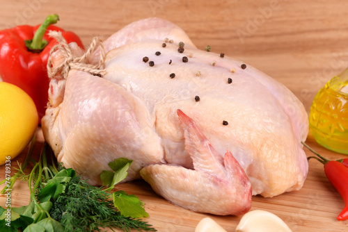 Raw chicken on wooden table