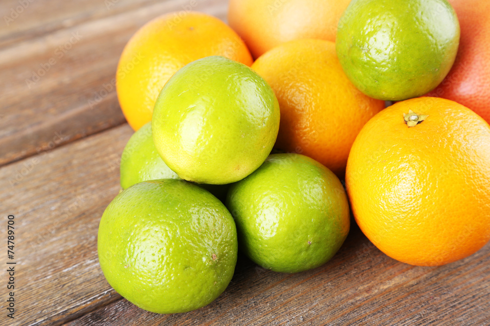 Lots ripe citrus on wooden background