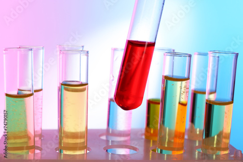 Test tube filled with red liquid on background of other tubes