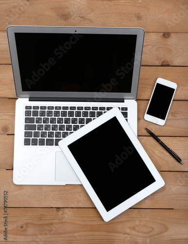 Open notebook, digital tablet and smart phone with pen