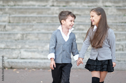 Portrait of a boy and a girl in school suit