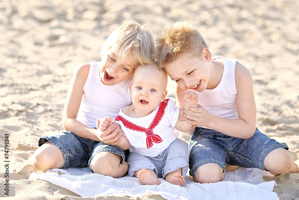 portrait of three little boys on the beach in summer portrait of three little boys on the beach in summer