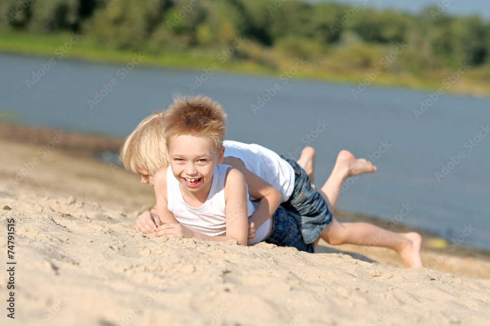 portrait of two little boys on the beach in summer portrait of two little boys on the beach in summer