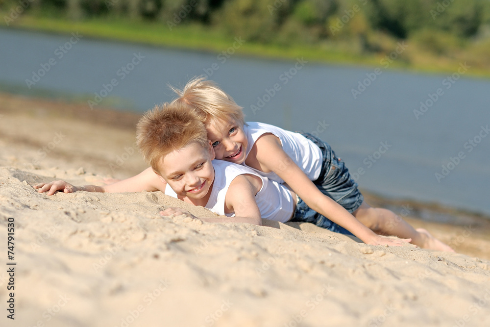 portrait of two little boys on the beach in summer portrait of two little boys on the beach in summer