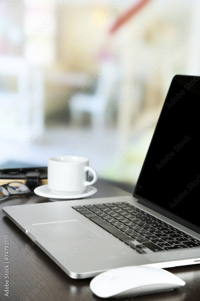 Modern laptop on table, on light background Modern laptop on table, on light background