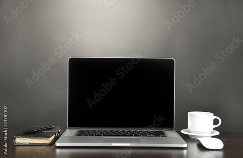 Fototapeta Naklejka Na Ścianę i Meble -  Modern laptop on table, on grey background