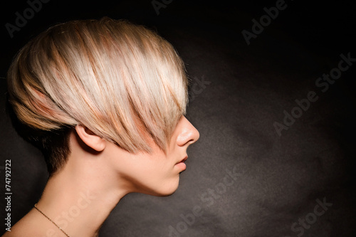 Wallpaper Mural Blonde girl with a short stylish haircut on a dark background Torontodigital.ca