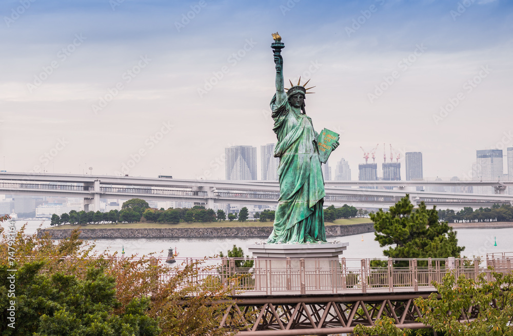 Lady liberty juxtaposed against Rainbow Bridge