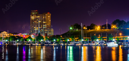 A marina and Federal Hill at night at the Inner Harbor in Baltim © jonbilous