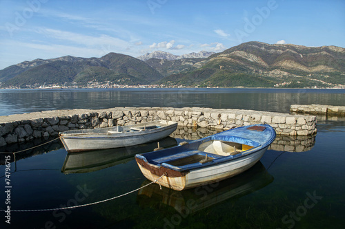 two boats in dock and mountains