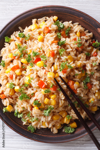 fried rice with eggs, corn and parsley closeup vertical top view