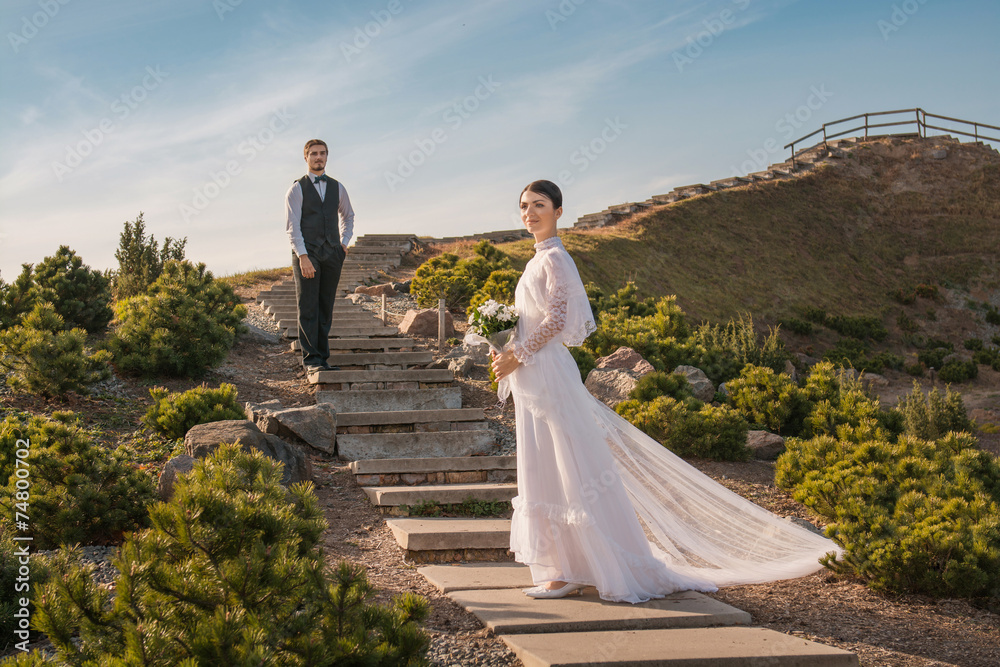 Romantic wedding couple standing on stair