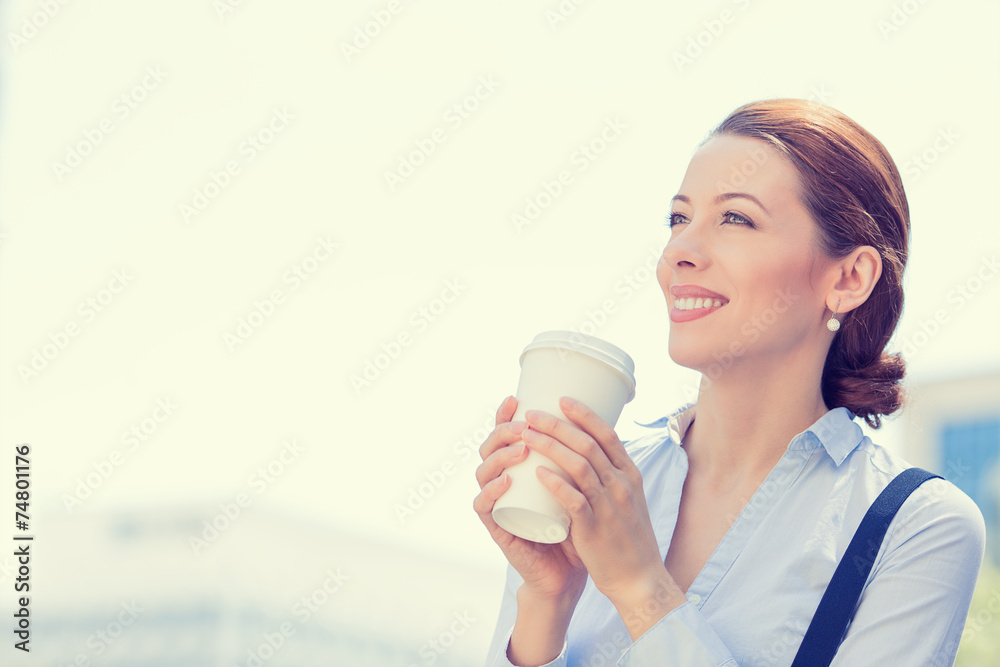 Happy woman drinking coffee in sun standing outdoor Happy woman drinking coffee in sun standing outdoor