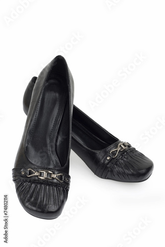modern female's black shoes over white background © Elena Milevska