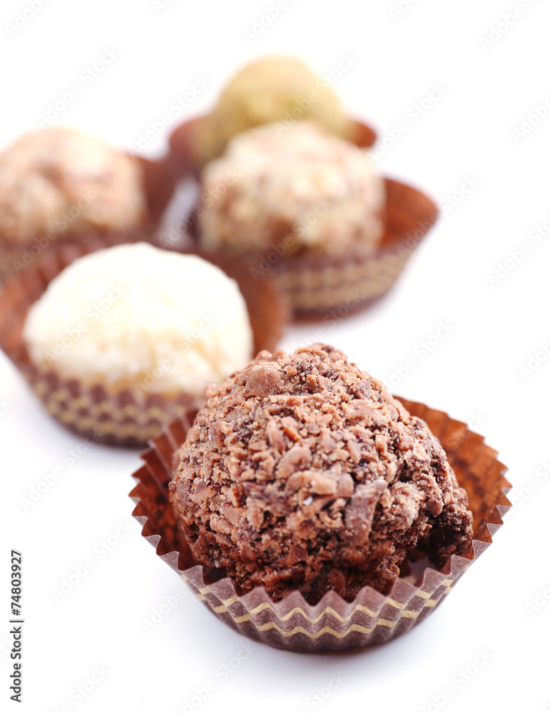 Sweet round candy wrapped in paper bowl on white background Sweet round candy wrapped in paper bowl on white background