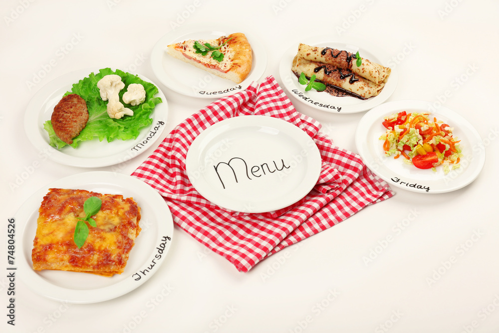 Daily menu. Plates with food on table Daily menu. Plates with food on table