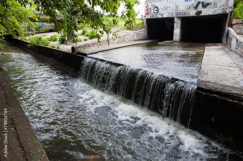 Принти на полотні Water stream flowing out the underground tunnel