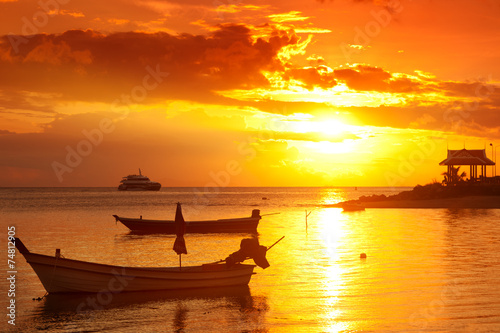 boats in sea at sunset, beautiful sunset © olezzo