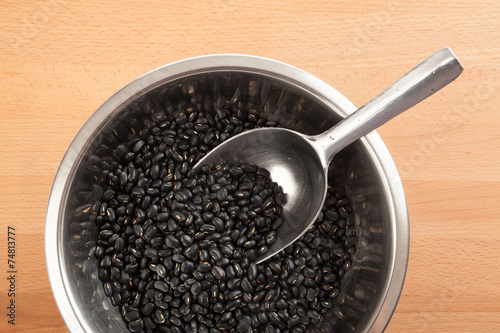 Black beans in bowl with transfer scoop