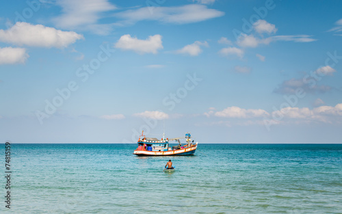 A man paddling a little boat