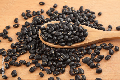 Black beans with wooden spoon