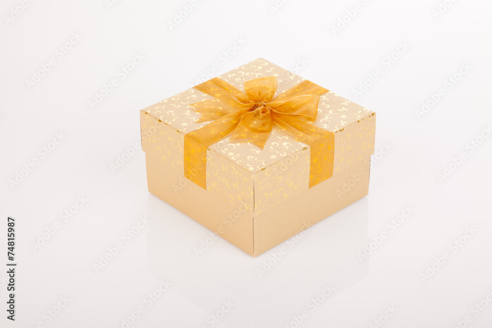 Golden gift box with golden bow on lid Golden gift box with golden bow on lid
