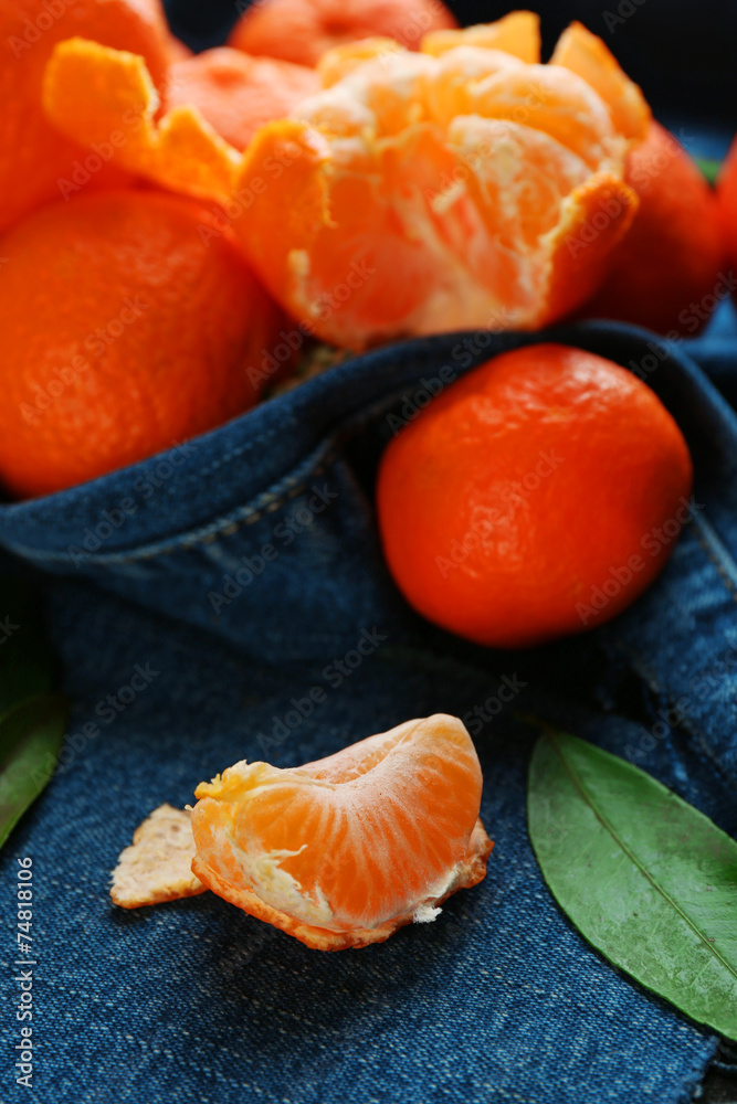 Fresh ripe mandarins on blue fabric background Fresh ripe mandarins on blue fabric background