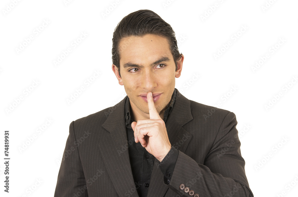 handsome young man wearing a suit posing gesturing silence handsome young man wearing a suit posing gesturing silence