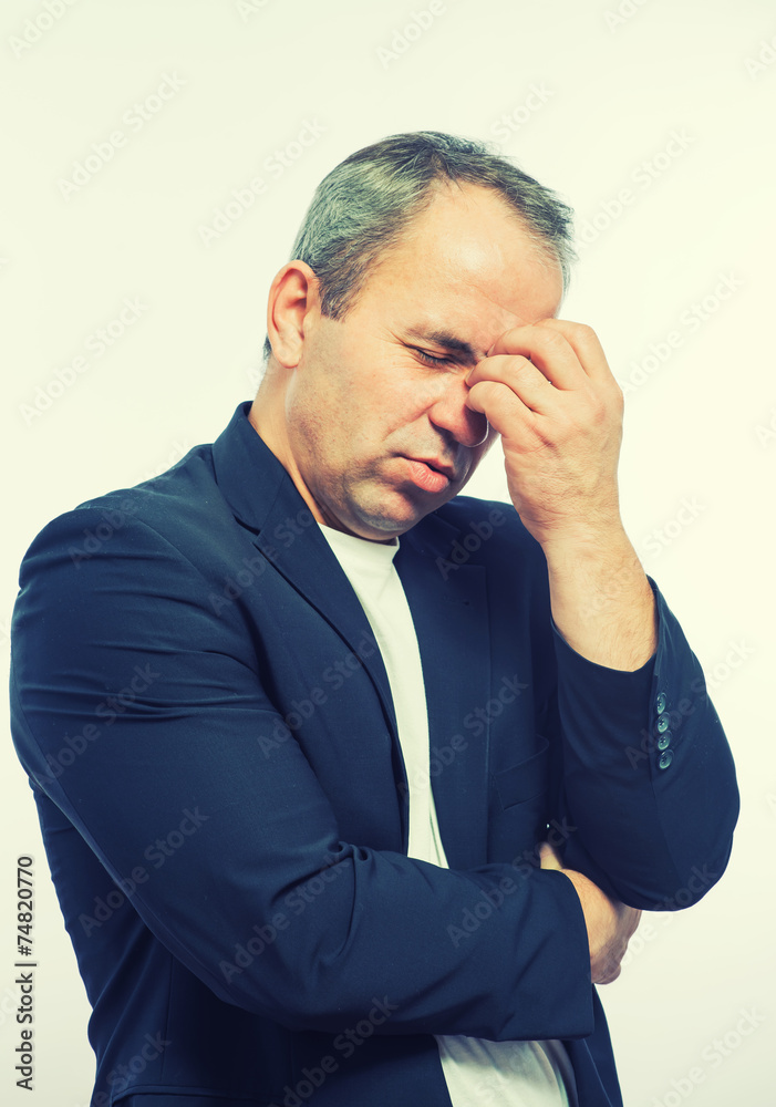 Businessman covering his face with both hands