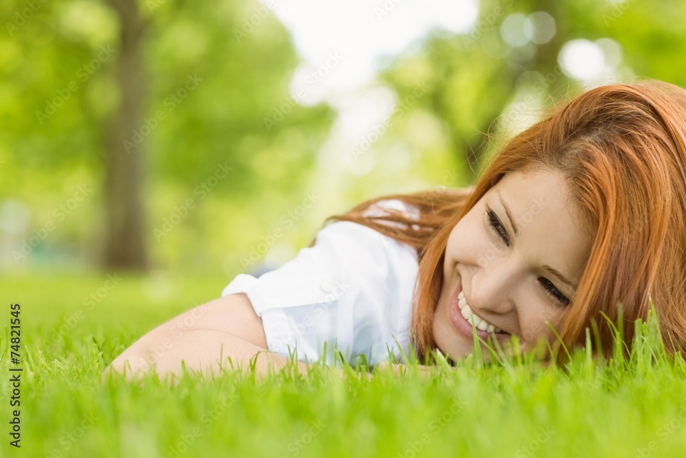 Portrait of a pretty redhead smiling and lying Portrait of a pretty redhead smiling and lying