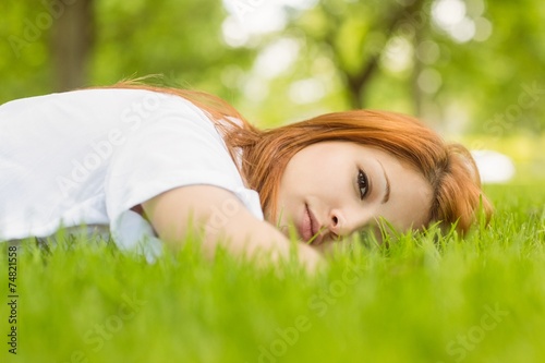 Portrait of a pretty redhead calm and lying