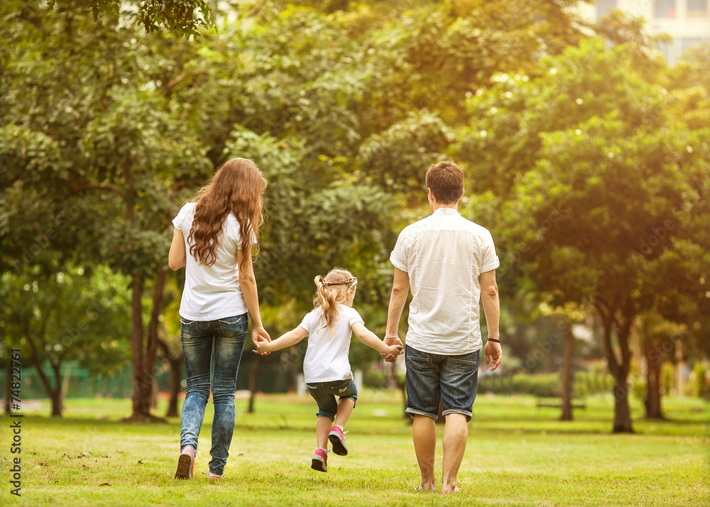 Family walk in the park, happy at sunset in Bangkok, Thailand. Family walk in the park, happy at sunset in Bangkok, Thailand.