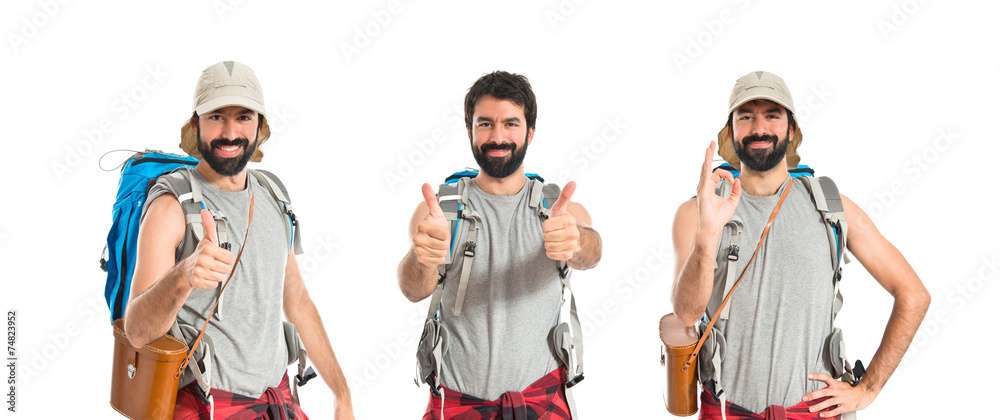 Fototapeta premium Backpacker with thumb up over white background