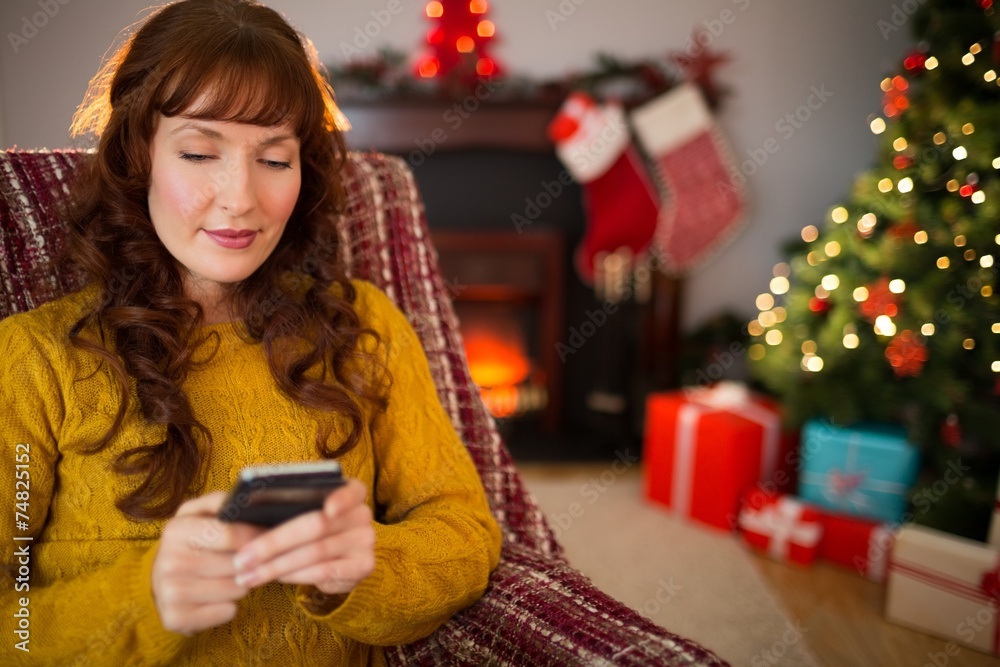 Content redhead using mobile at christmas Content redhead using mobile at christmas