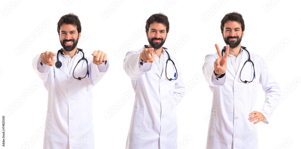 Doctor pointing to the front over white background Doctor pointing to the front over white background