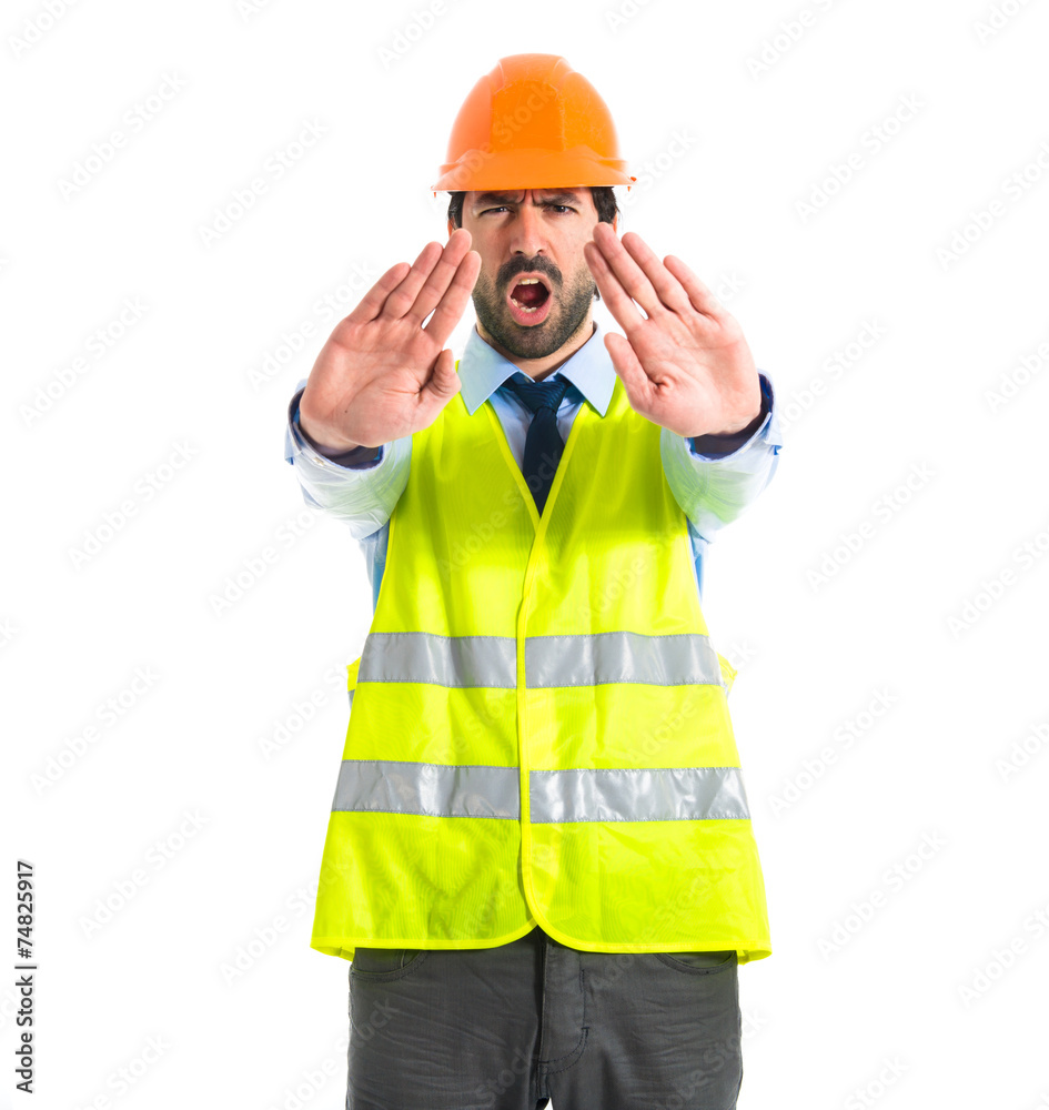 workman making stop sign over white background